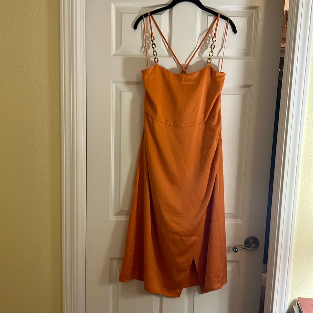 Pumpkin colored satin slip dress with faux wrap and tortoise shell straps.